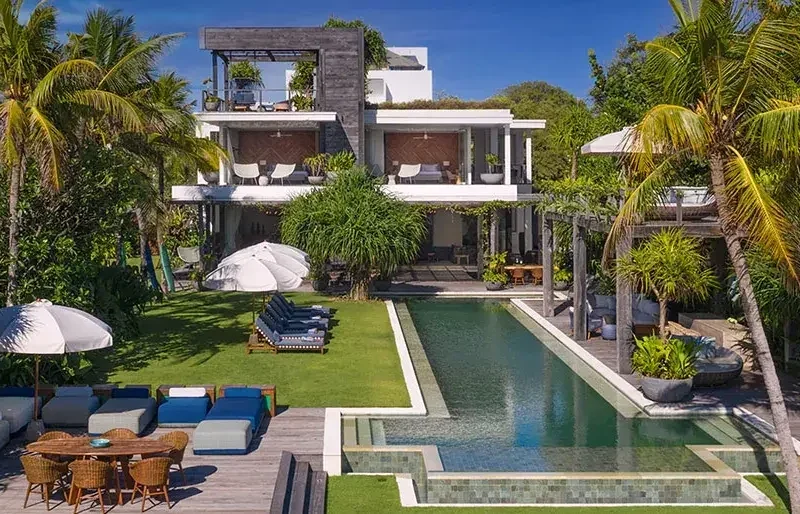 Aerial view of a beachside villa and pool in Bali